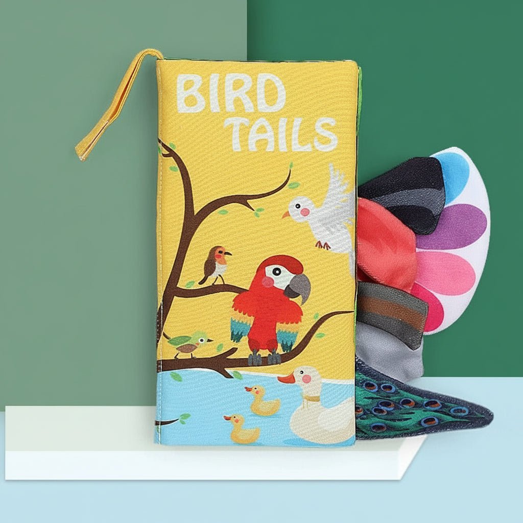 Children's cloth book titled 'Bird Tails' with colorful illustrations on a green and blue gradient background.